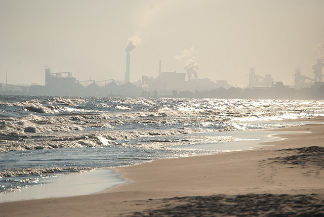 A factory sits next to a beach. Steve Johnson/Flickr