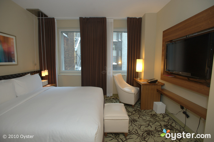 The Deluxe Room at Cassa Hotel & Residences is 325 square feet and has a queen bed.