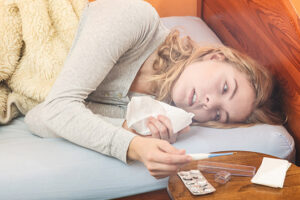 Photo: Woman Sick in Bed via Shutterstock