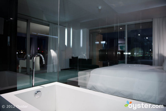 The glass-walled bathroom lets anyone in the Master Bedroom sneak a peek.