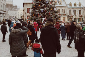 Christmas tree with people around in a city square